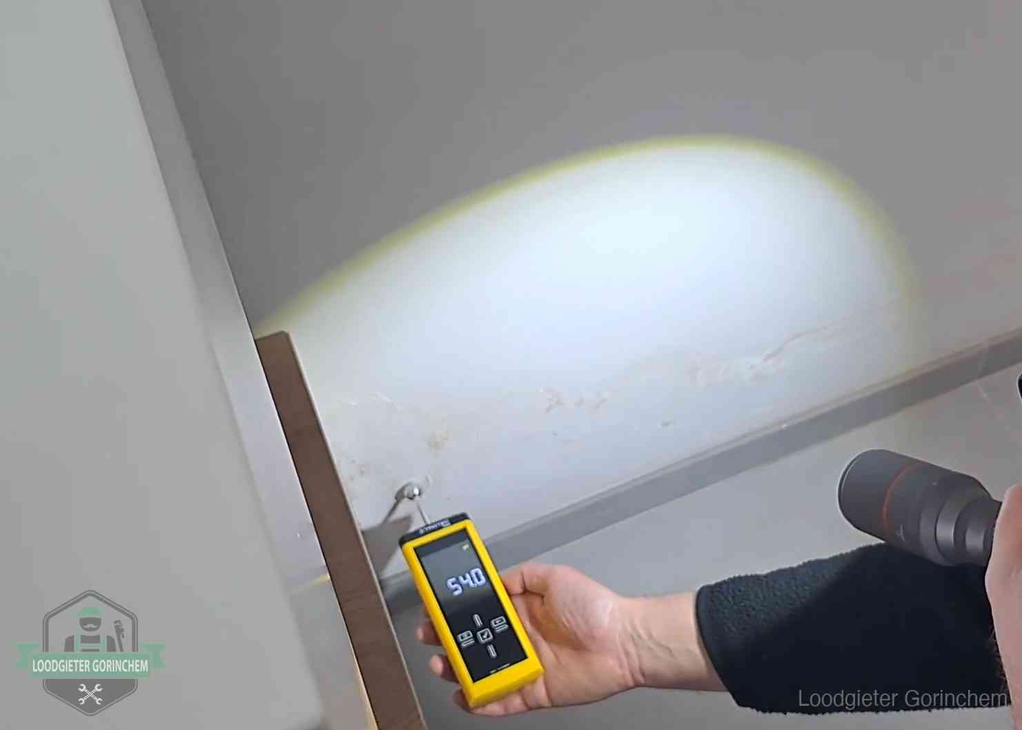Vochtmeter tegen een natte wand met lekkagesporen in Gorinchem