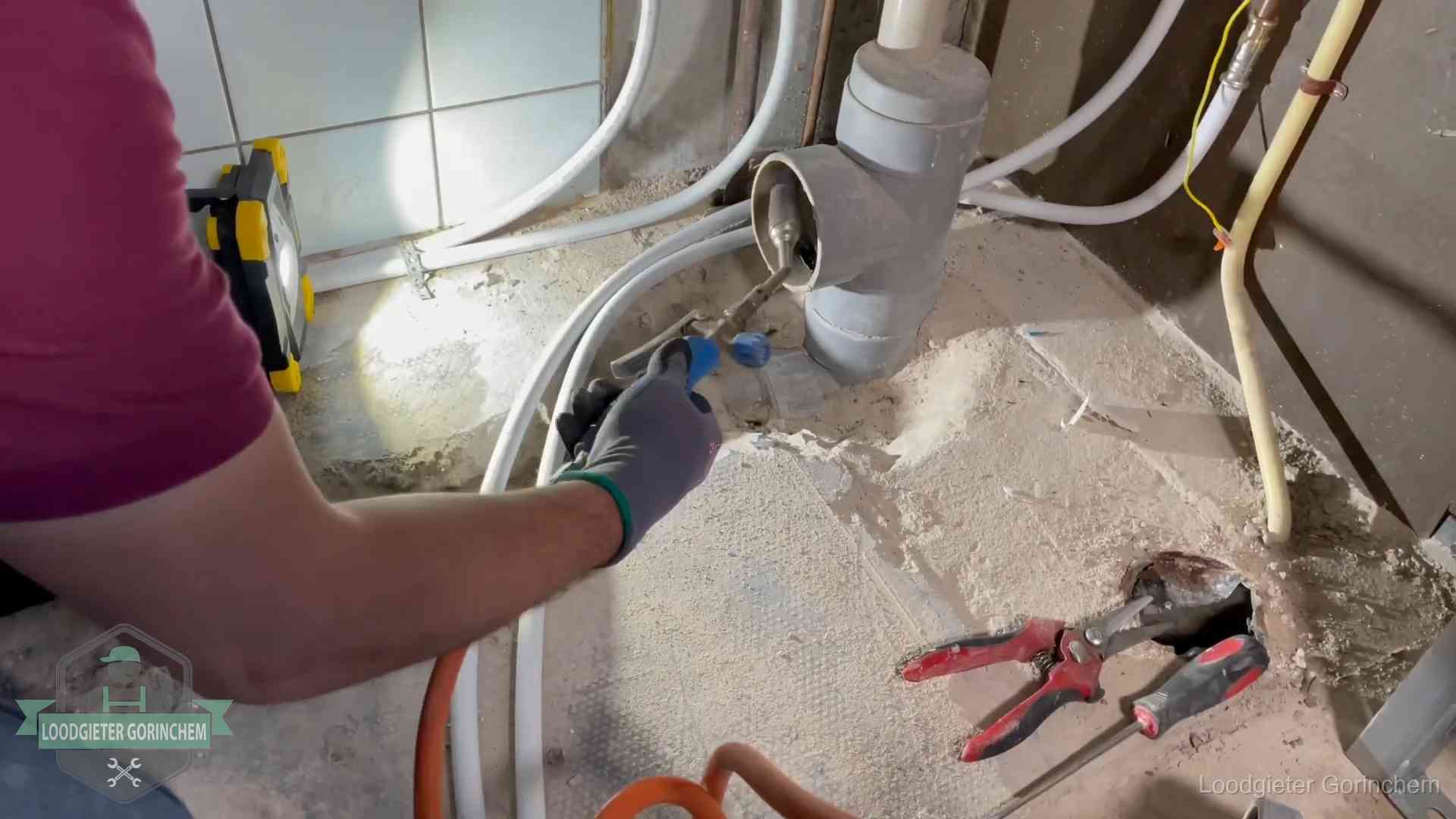 Loodgieter werkt aan leidingen bij een pvc-standleiding in een appartement in Gorinchem